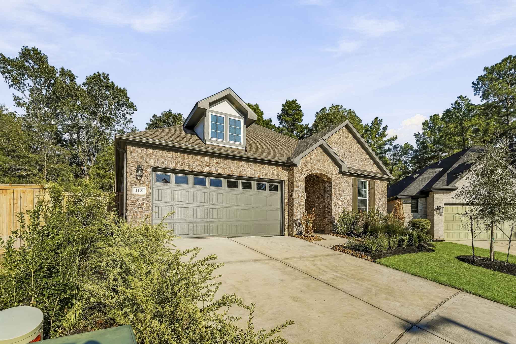 A house with a driveway and trees.