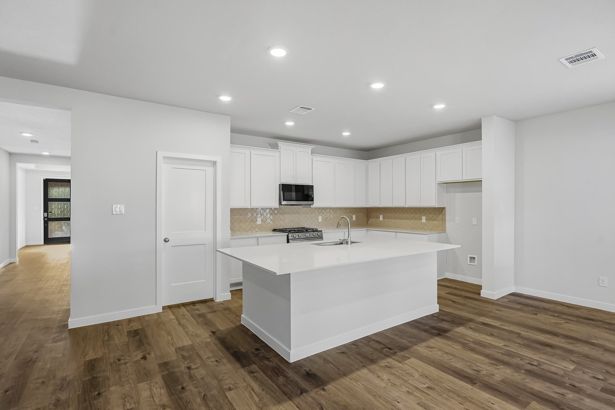 A large kitchen with white cabinets.