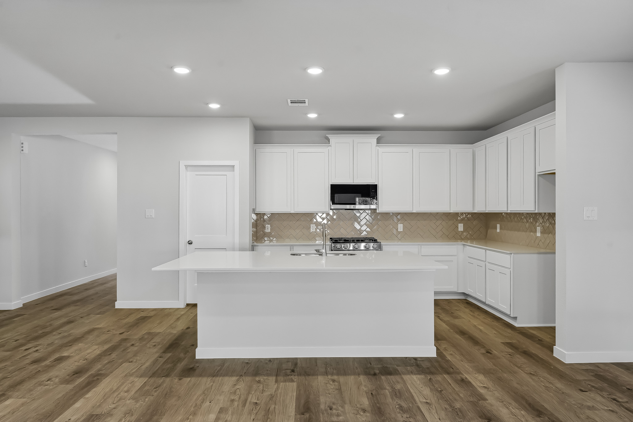 A kitchen with white cabinets.