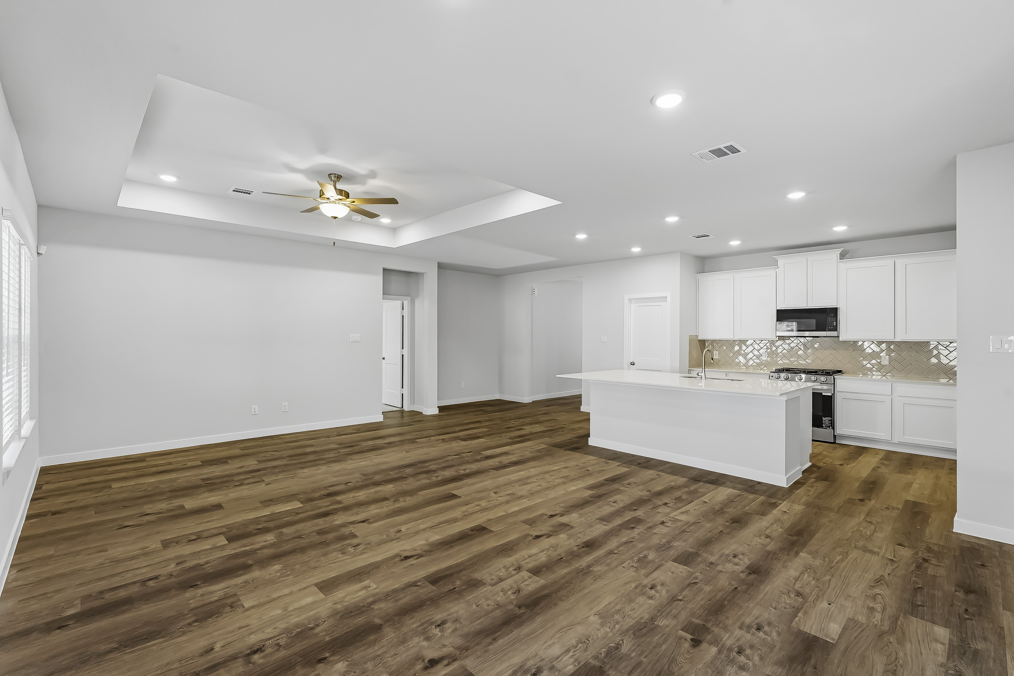 A large kitchen with white cabinets.