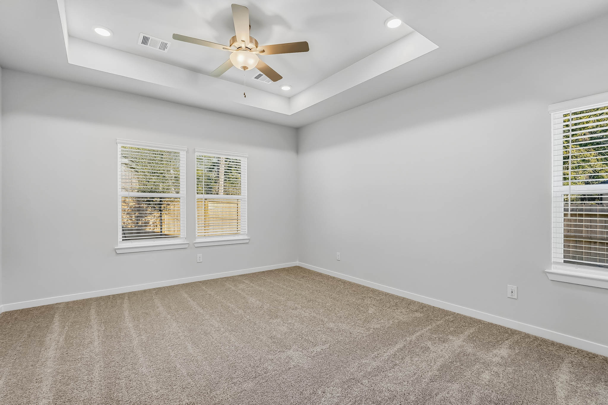 A room with a ceiling fan and a window.