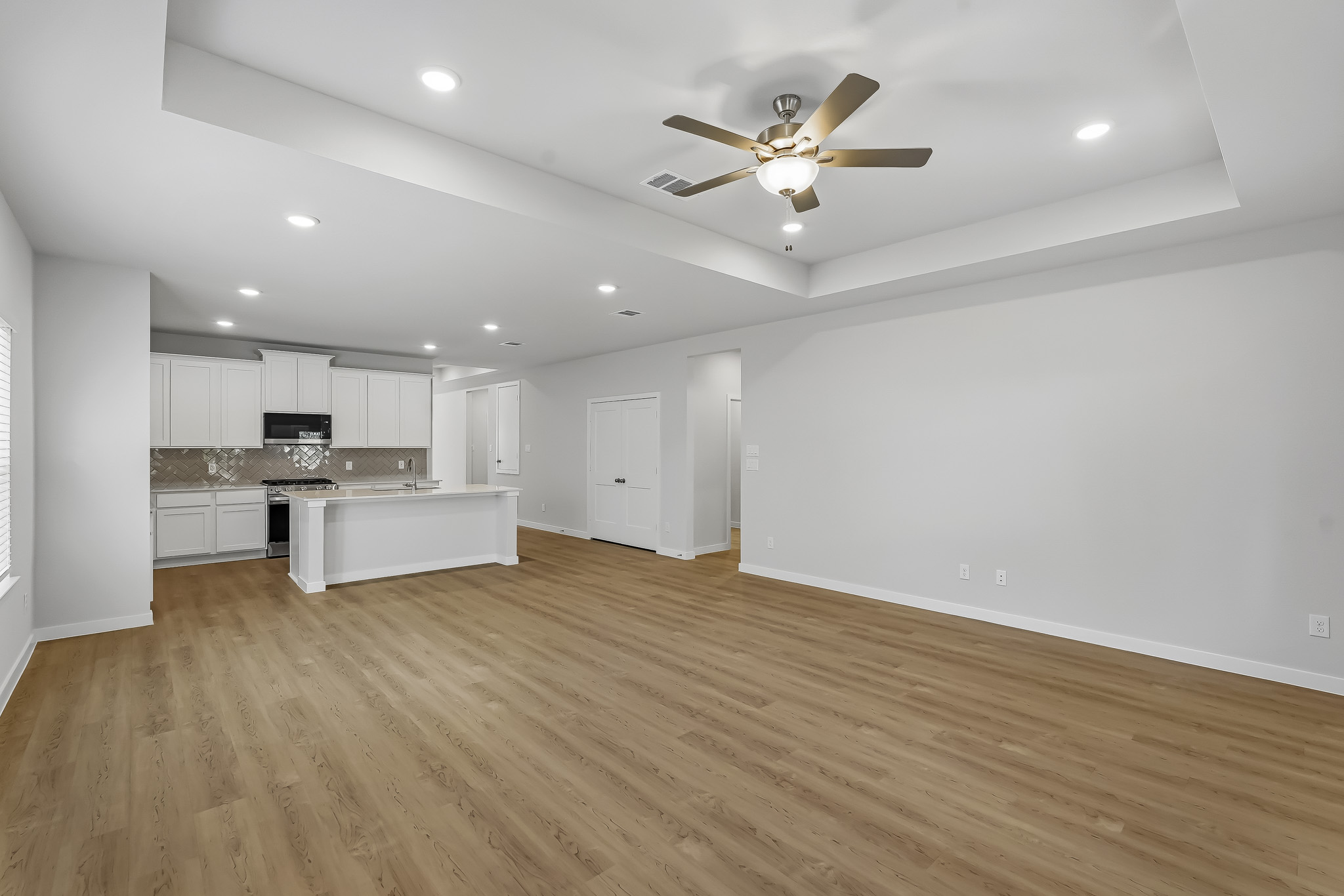 A large kitchen with white walls.