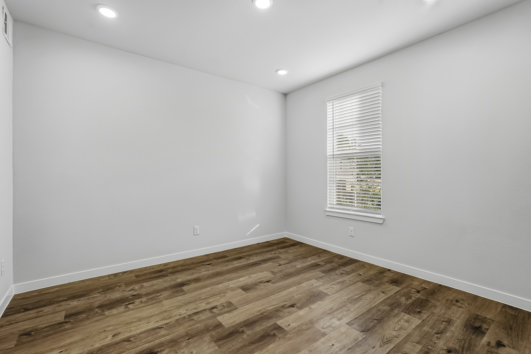 A room with a wood floor and a wood floor.
