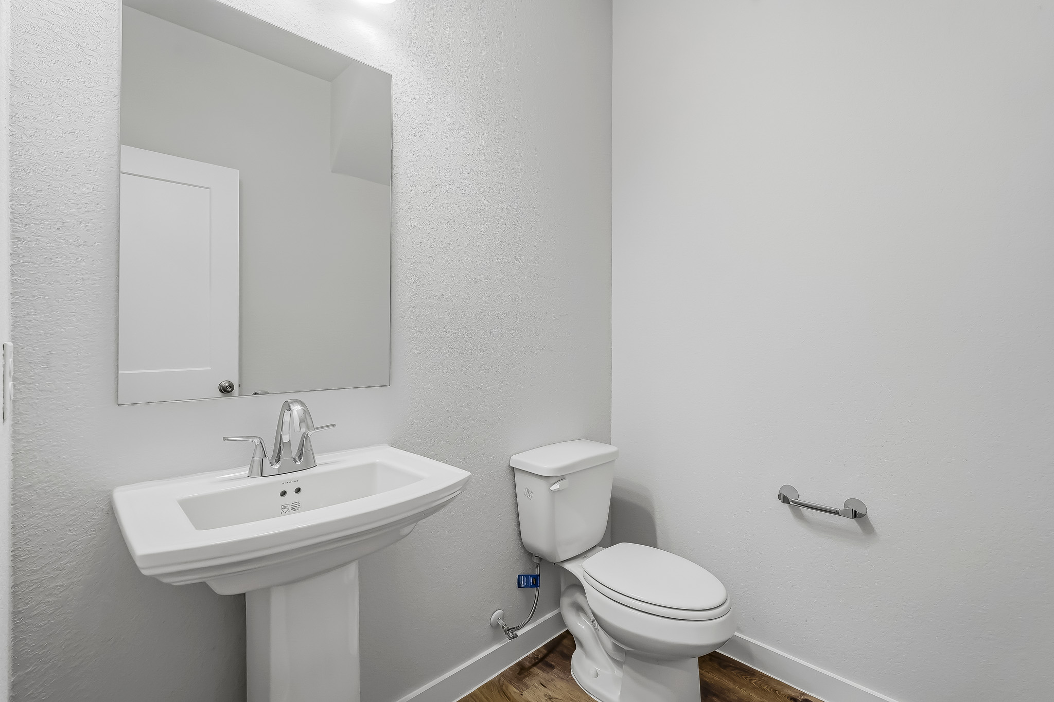 A bathroom with a toilet and sink.