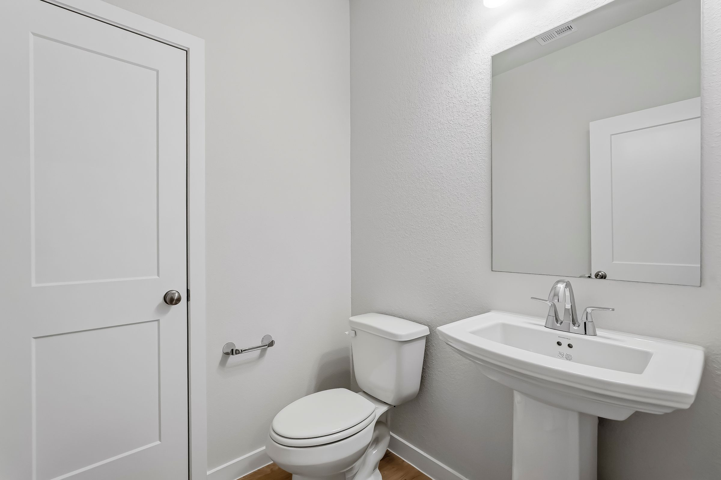 A bathroom with a toilet and sink.