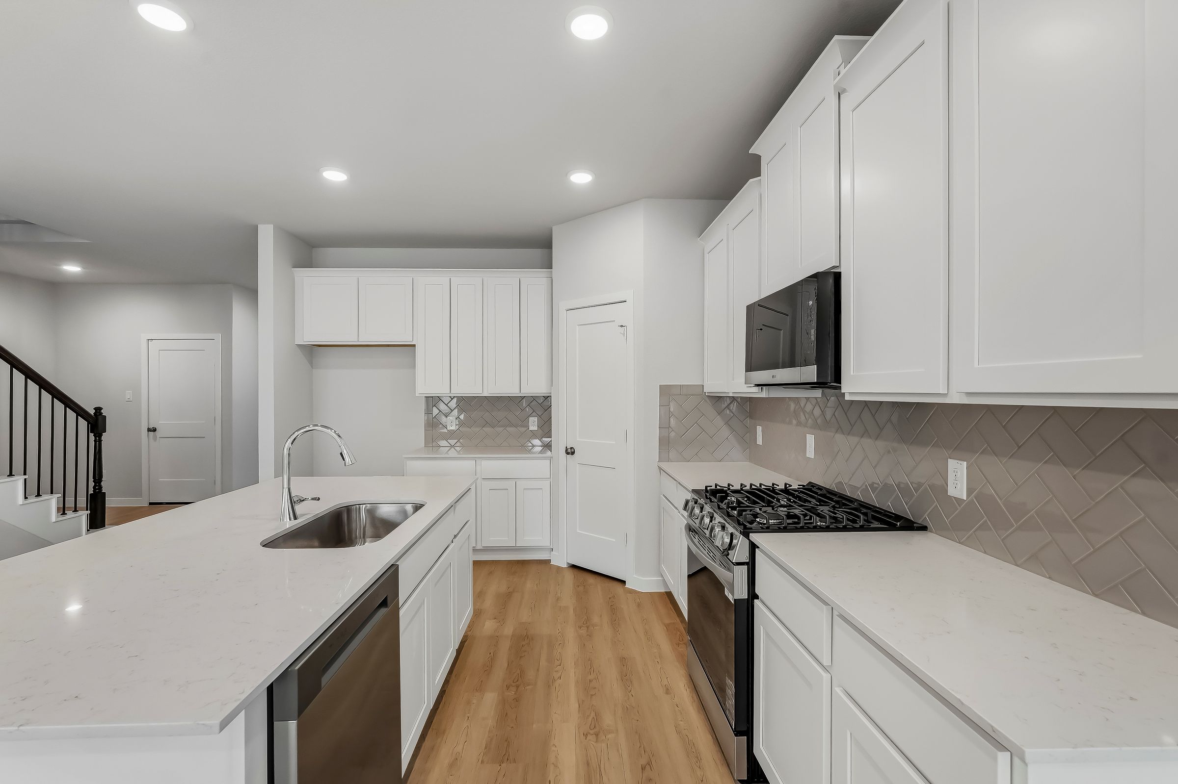 A kitchen with white cabinets.