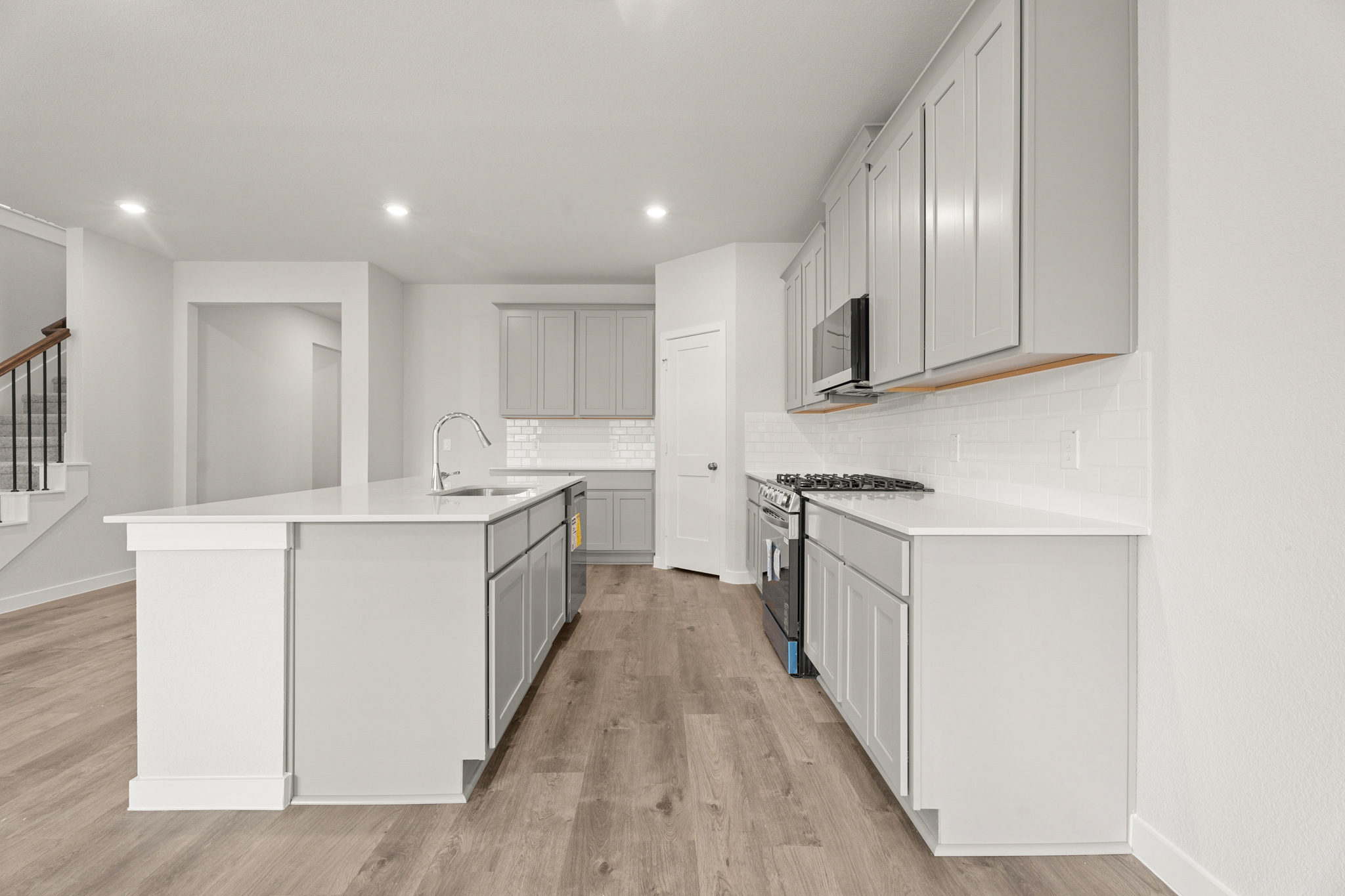 A kitchen with white cabinets.