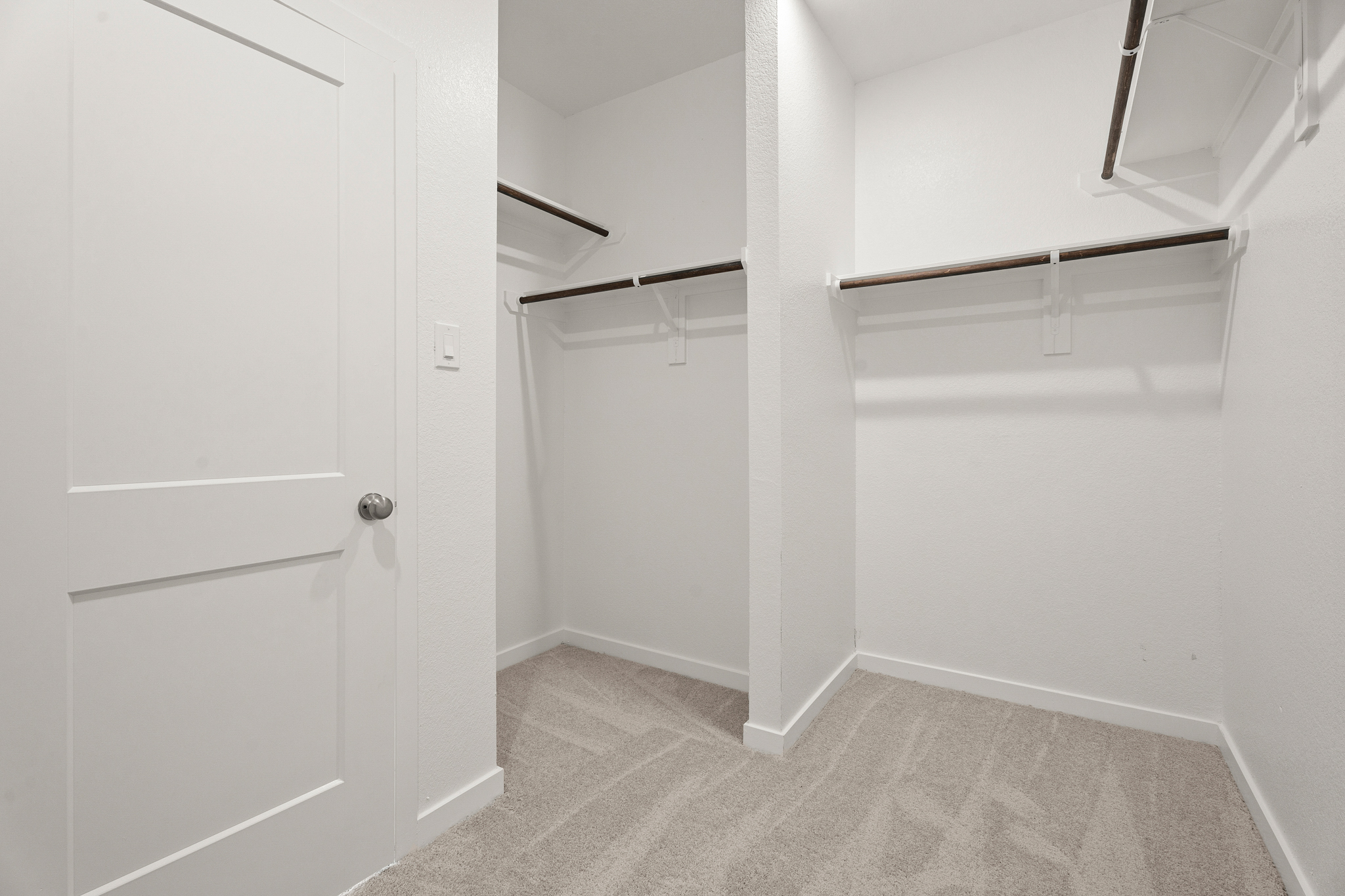 A white room with a white door.