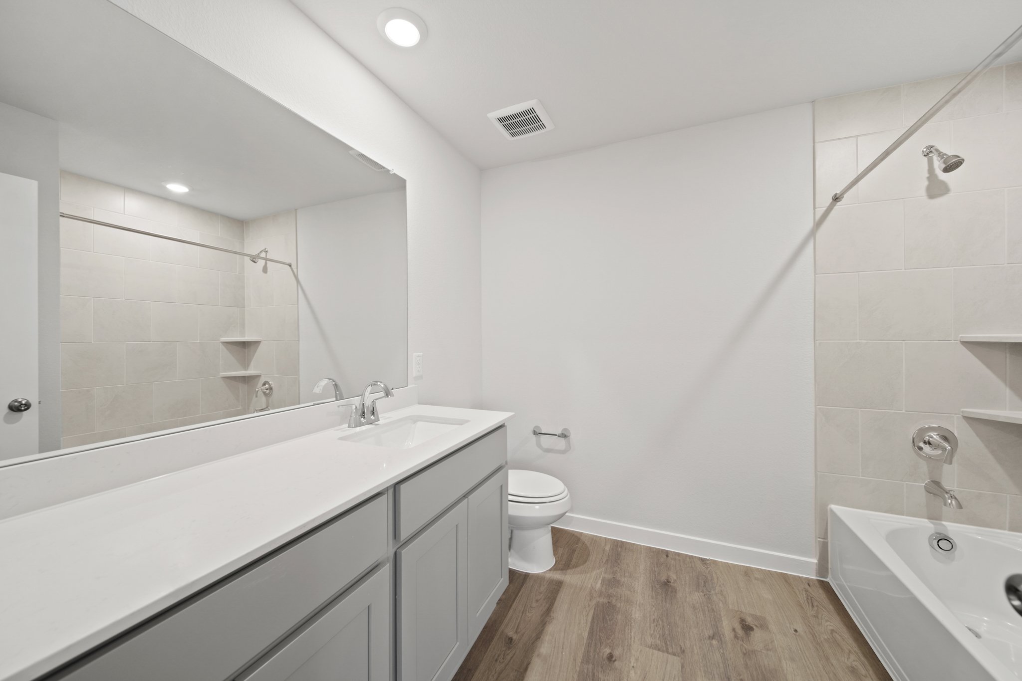 A bathroom with a tub toilet and sink.
