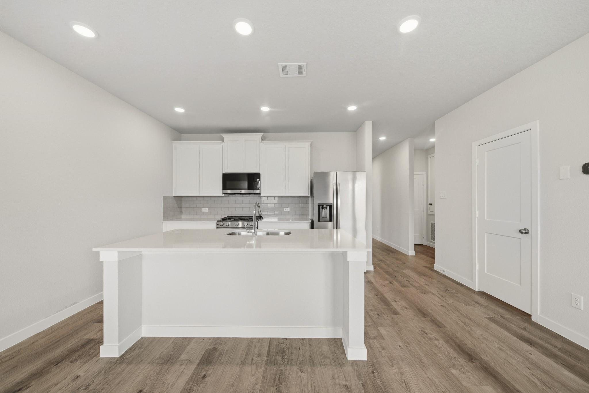 A kitchen with white cabinets.