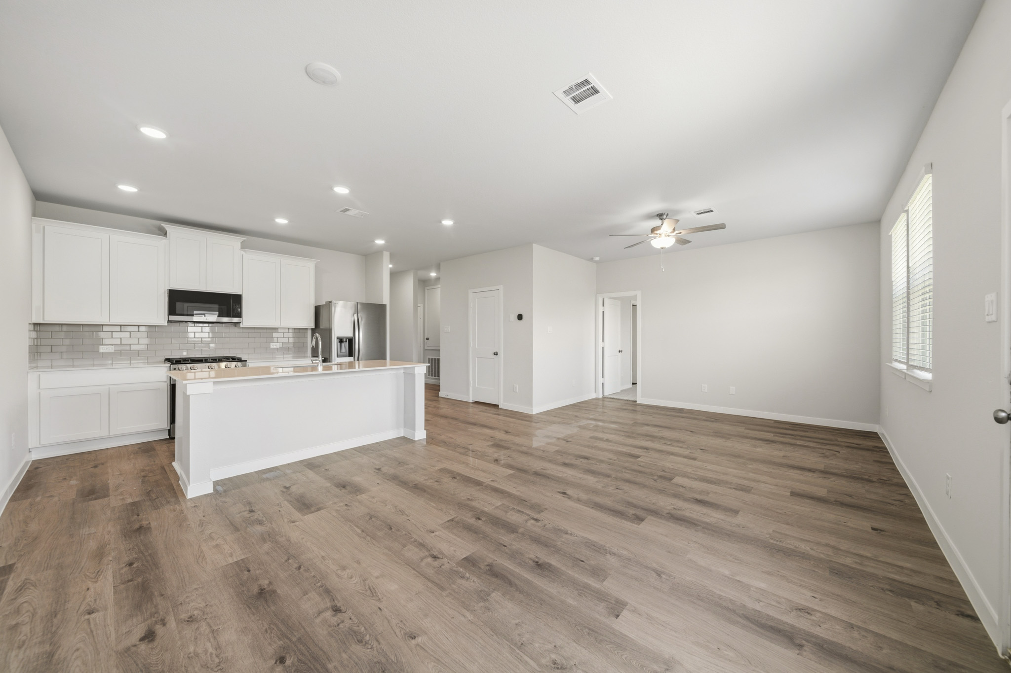 A large kitchen with white cabinets.