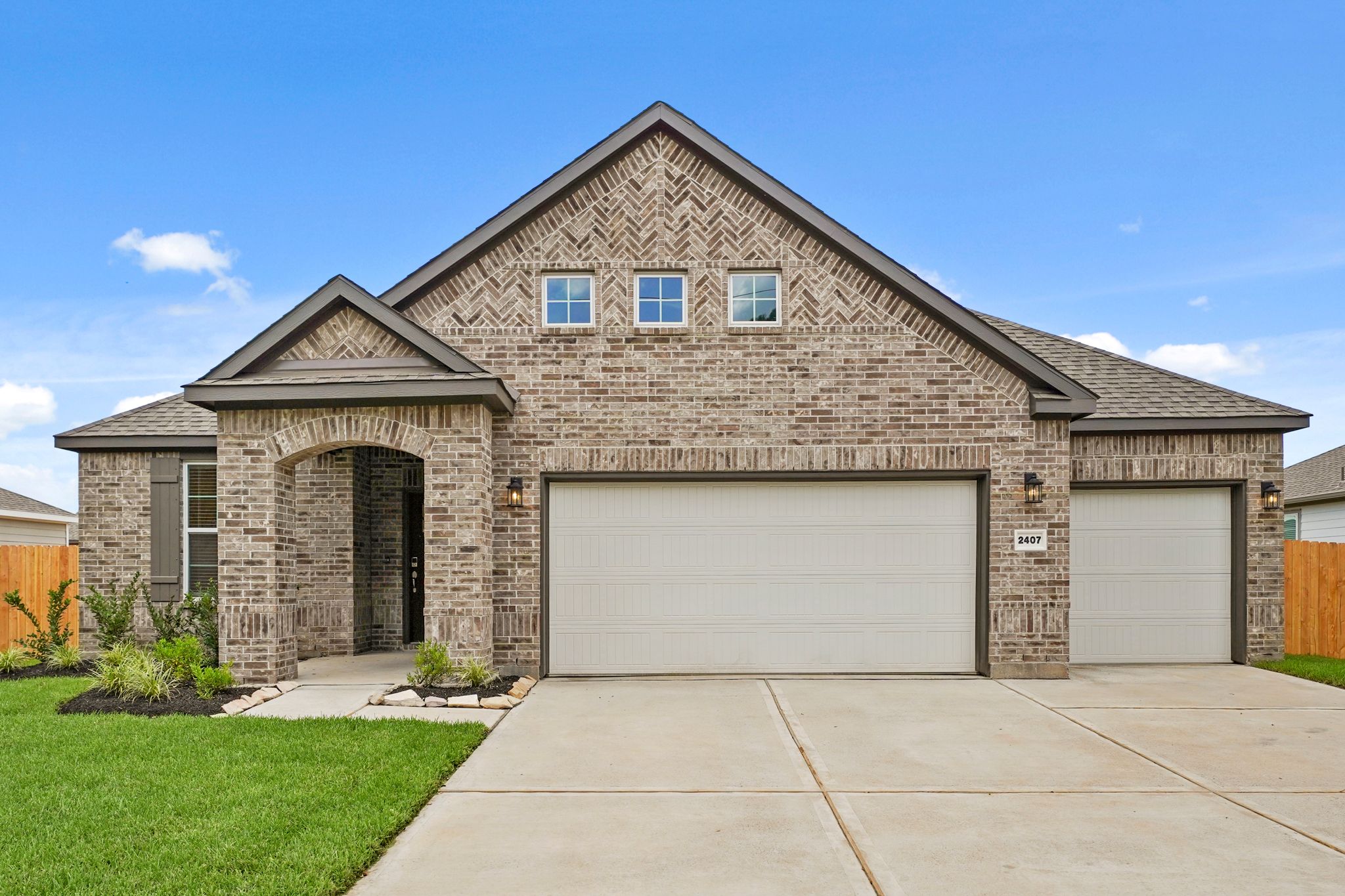 A house with garages and a driveway.