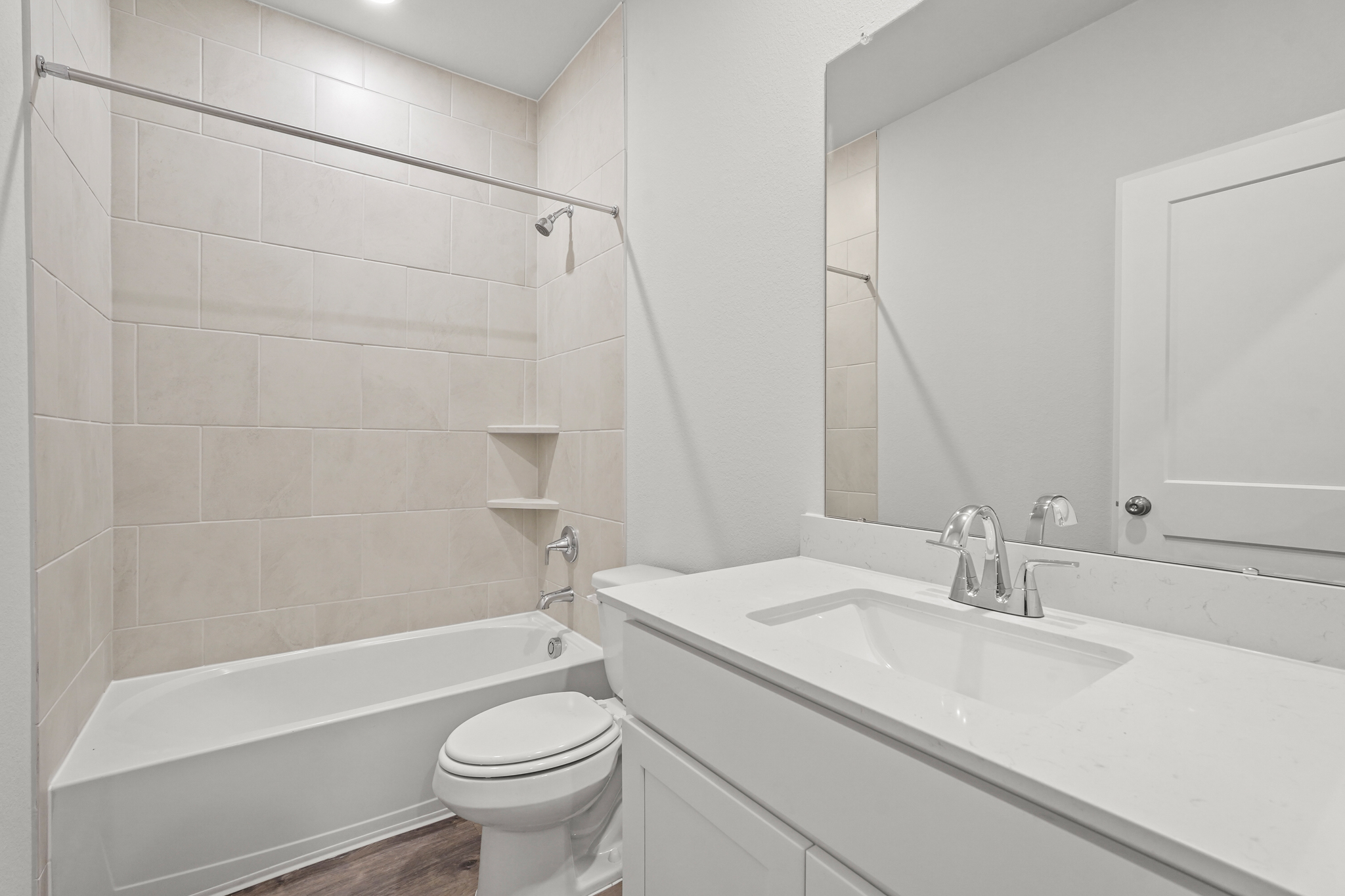 A bathroom with a tub sink and toilet.