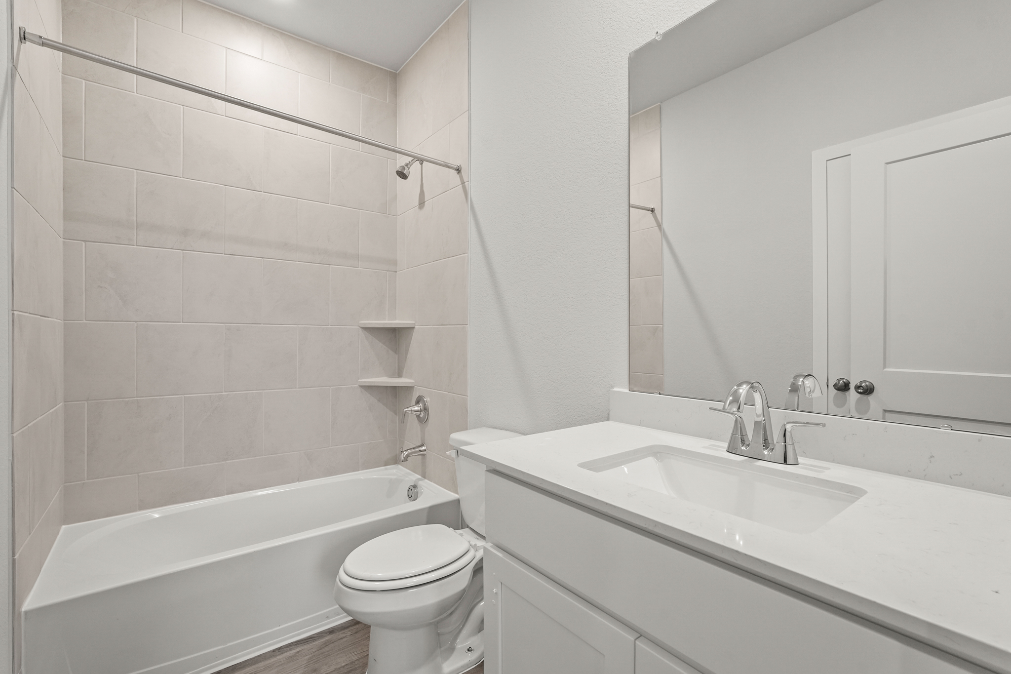 A bathroom with a tub sink and toilet.