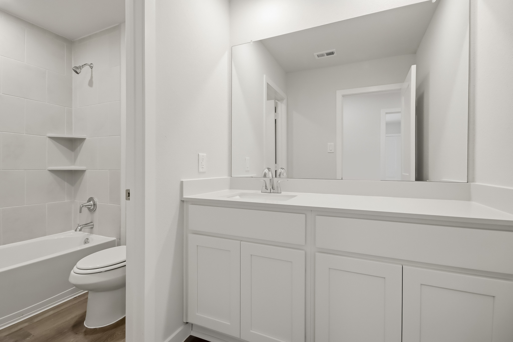 A bathroom with a sink toilet and bathtub.