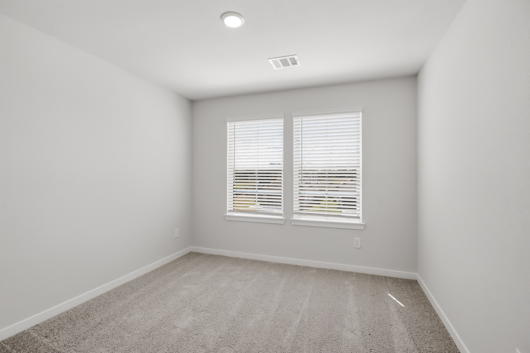 A room with a window and a carpet.