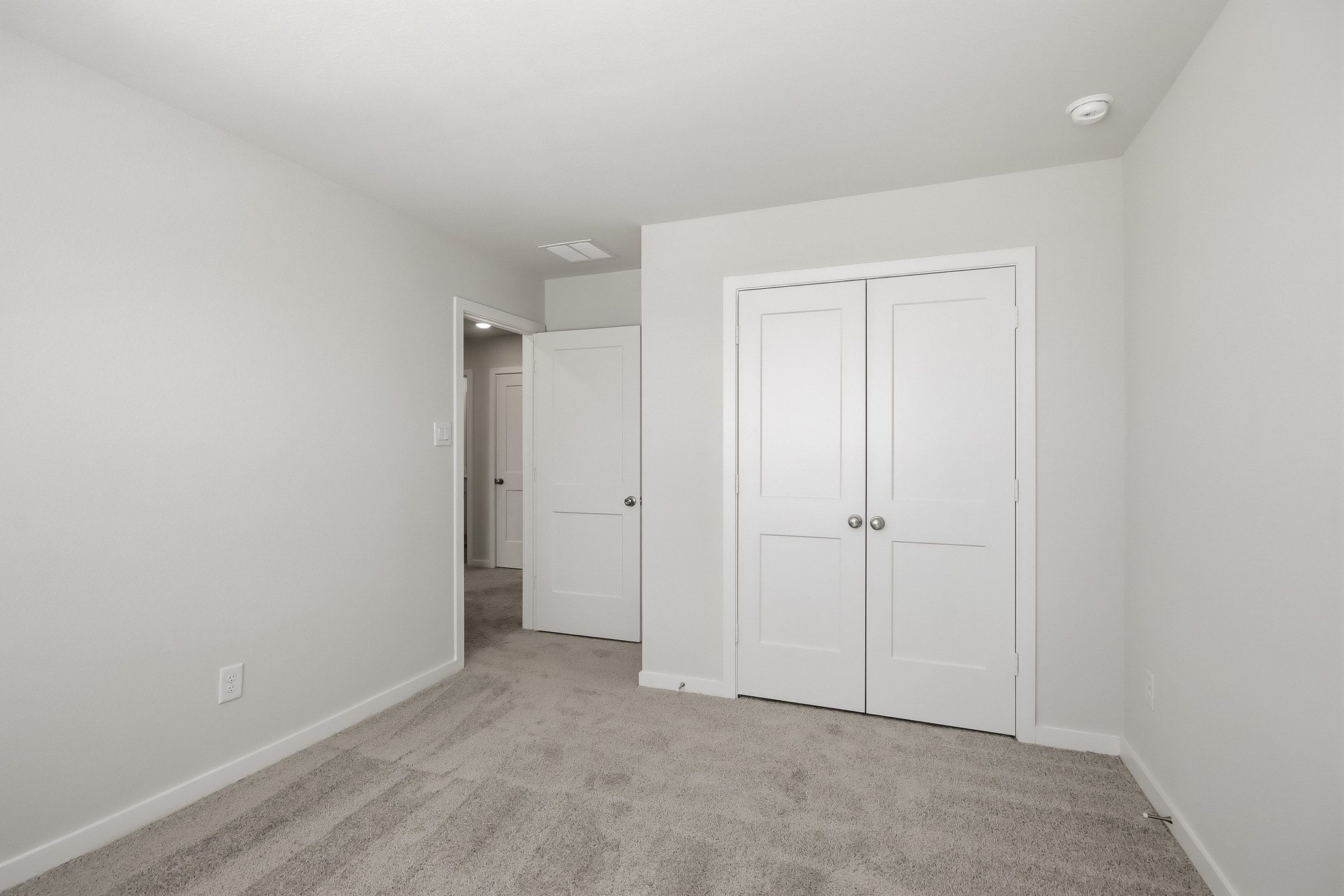 A hallway with white doors.