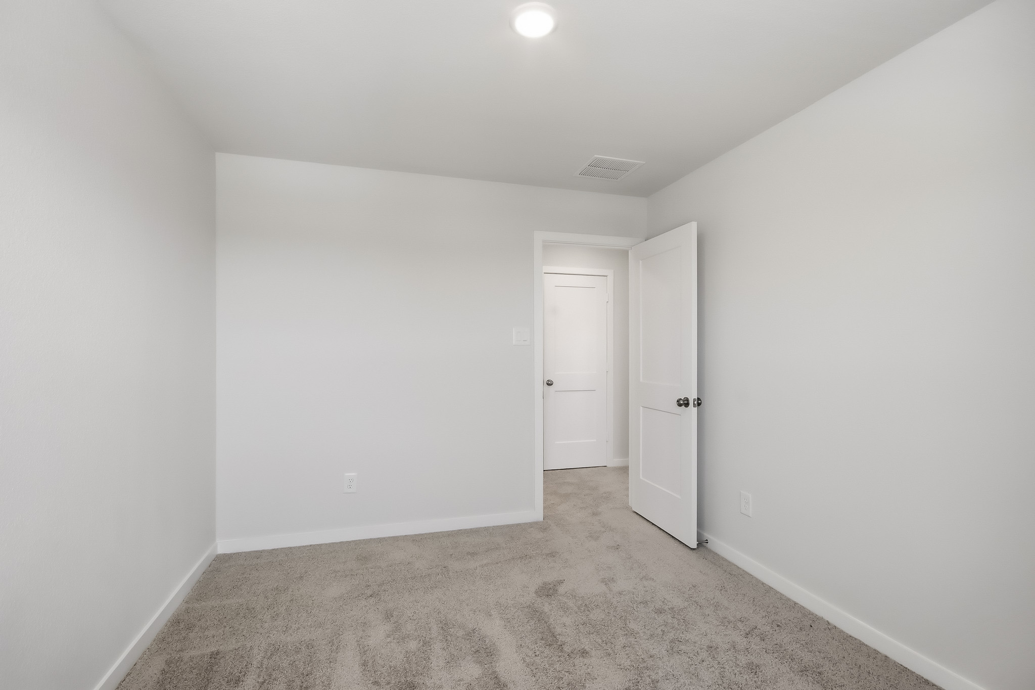 A hallway with white doors.