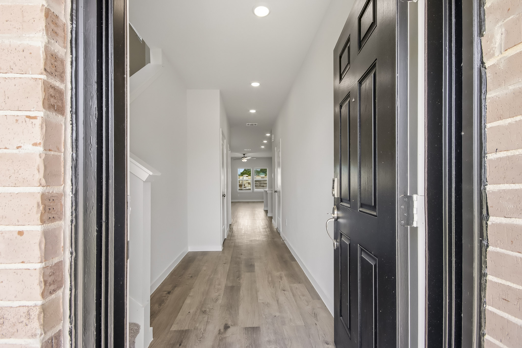 A hallway with black doors.