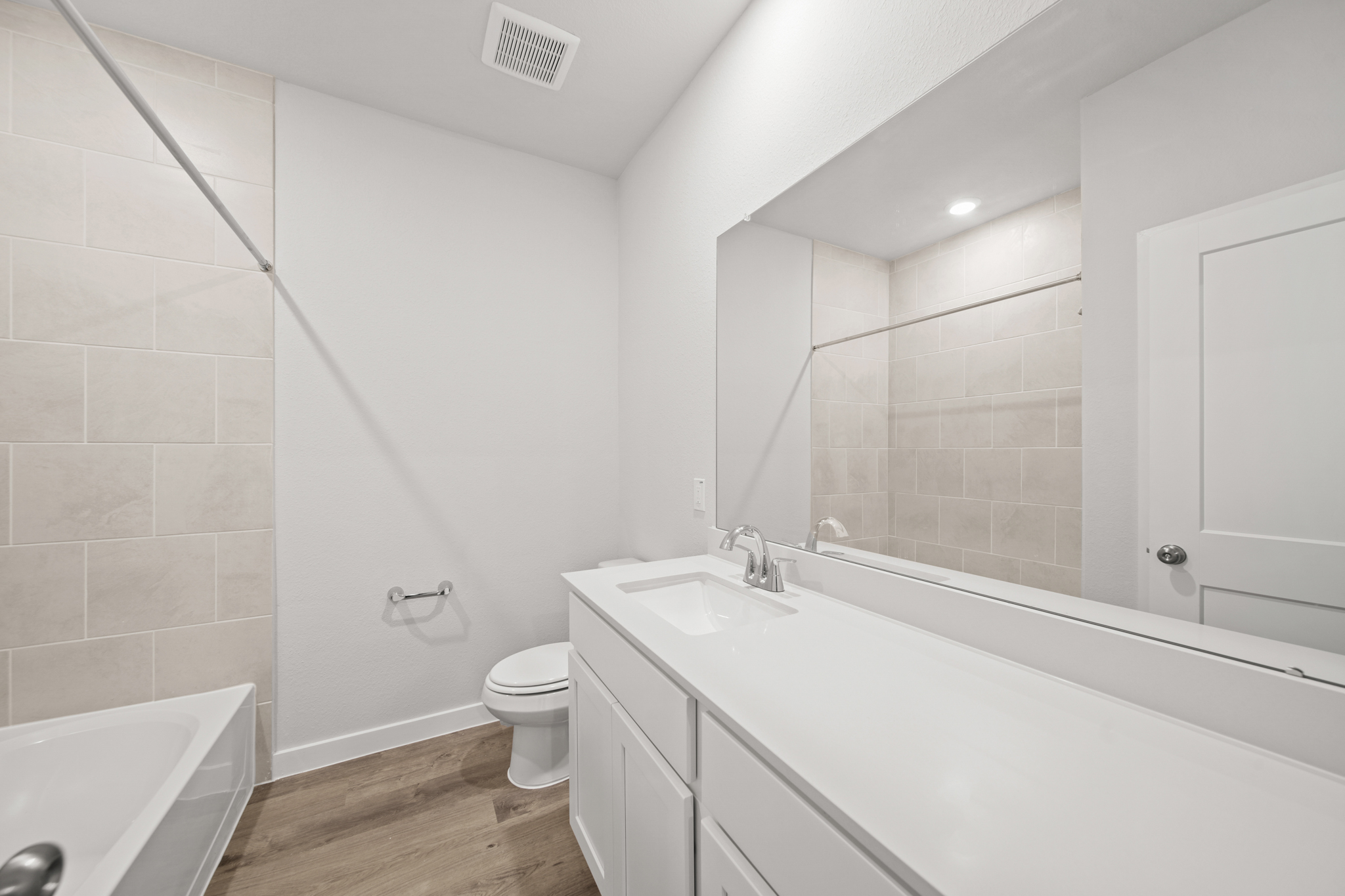 A bathroom with a tub toilet and sink.