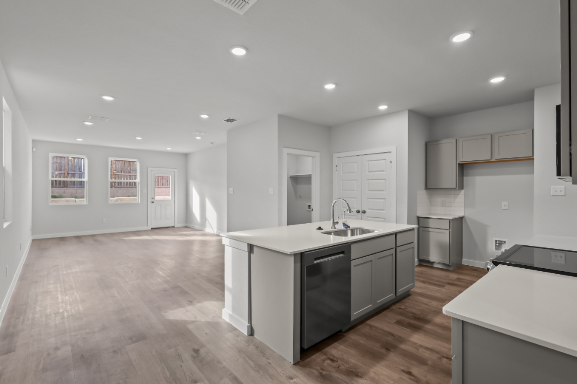 A kitchen with white cabinets.
