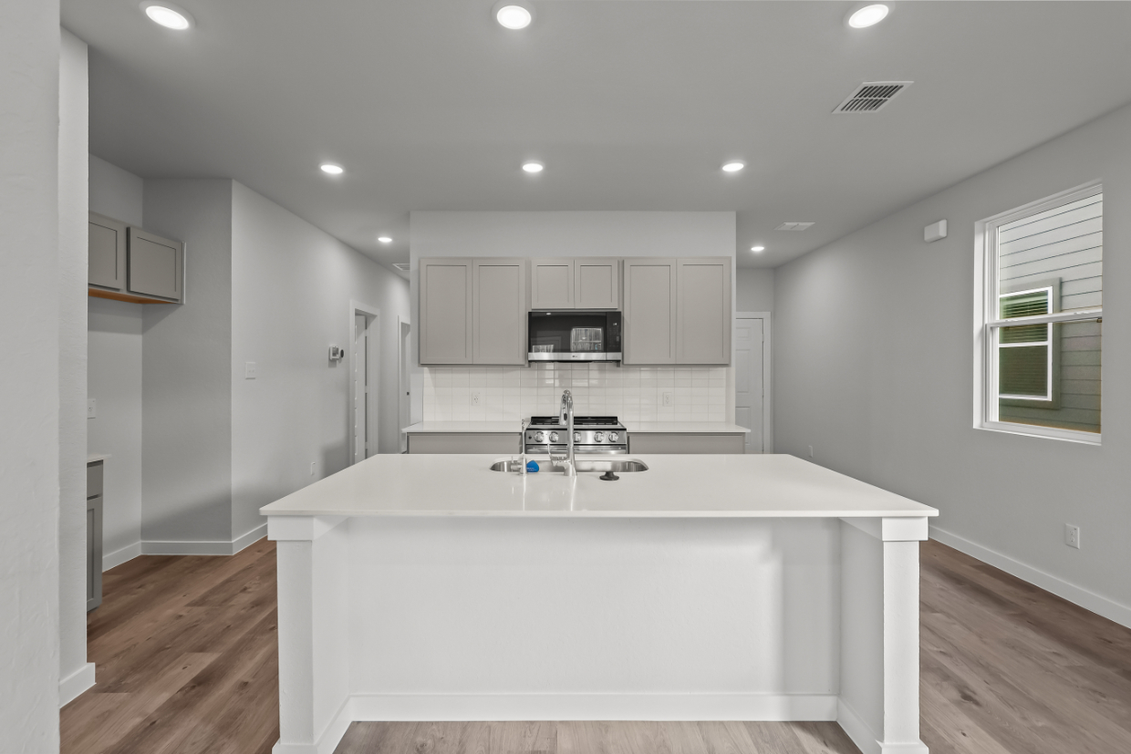 A kitchen with a sink and a counter top.