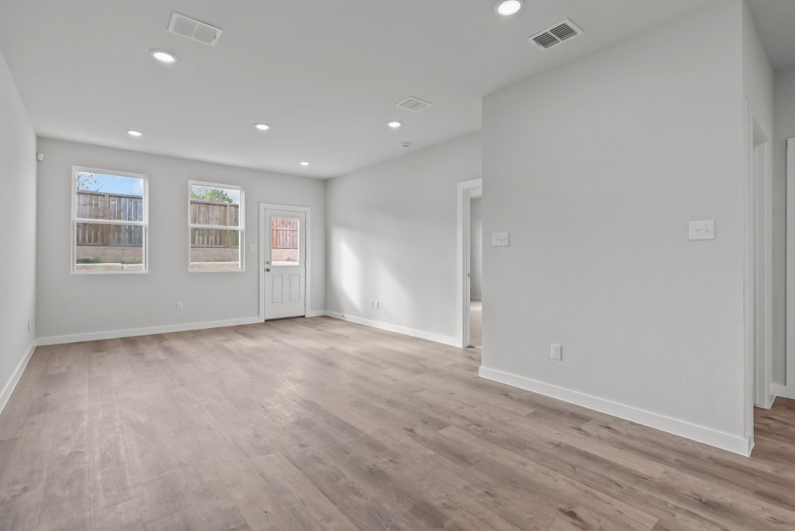 A room with a wood floor and white walls.