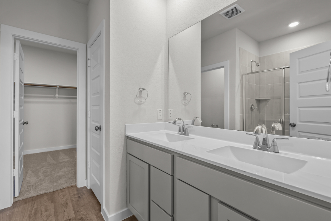 A bathroom with a large mirror.