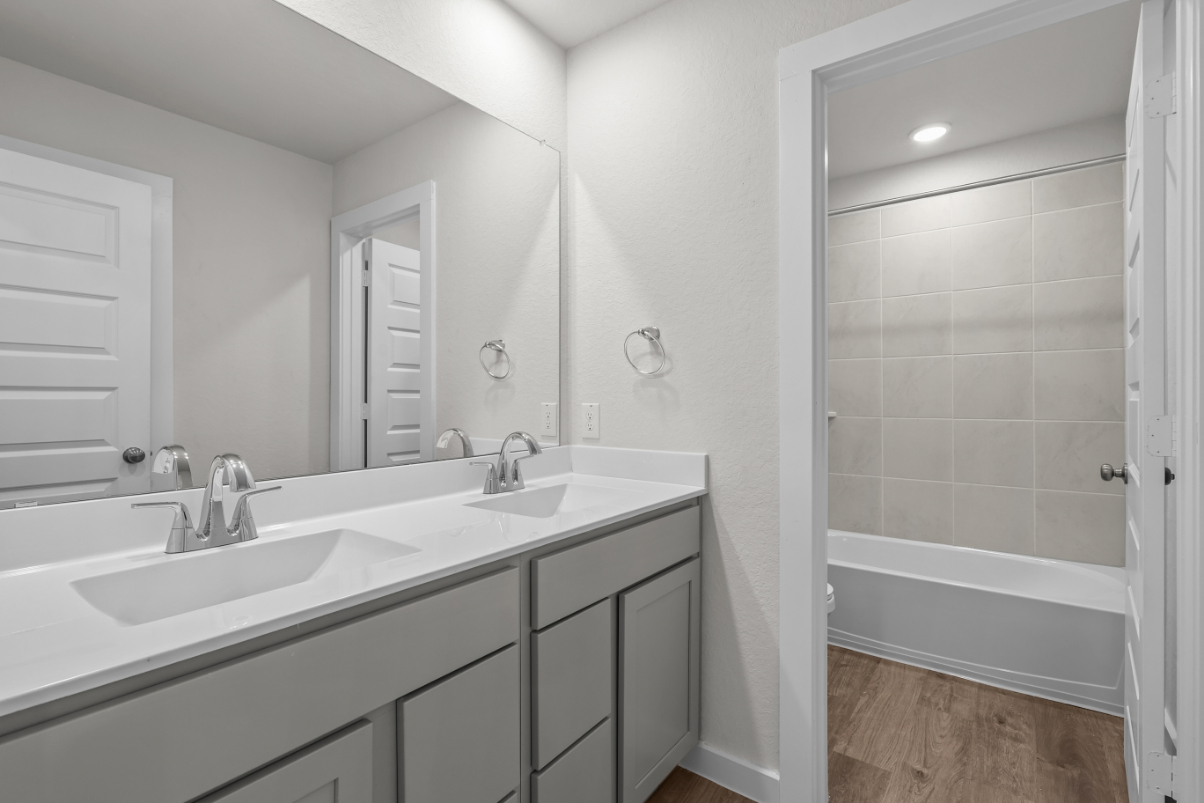 A bathroom with a tub sink and a shower.