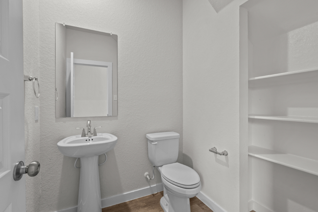 A bathroom with a toilet and sink.