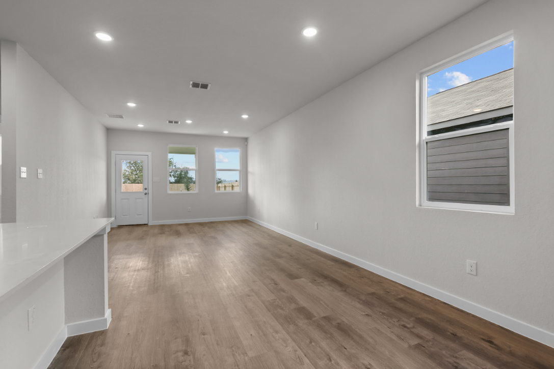 A room with white walls and a wood floor.