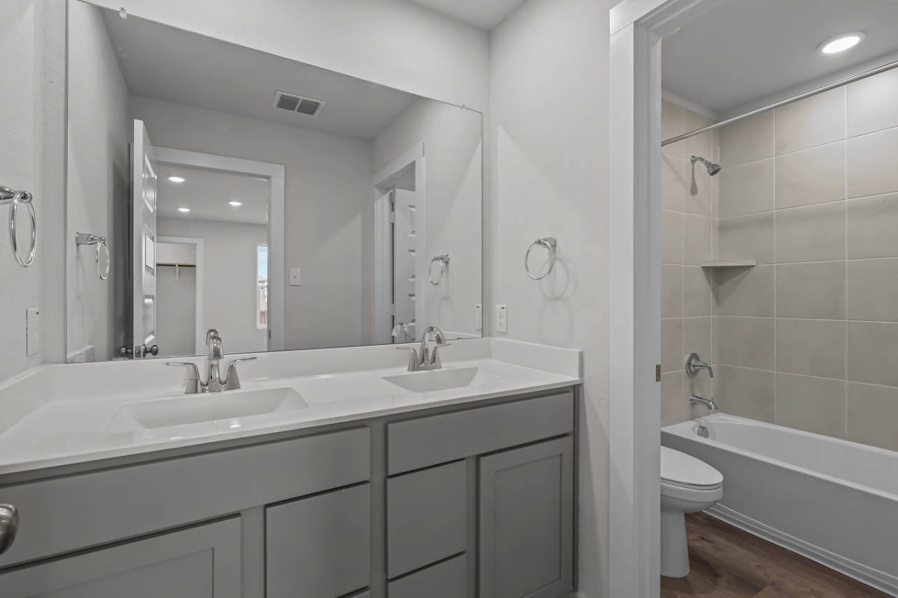 A bathroom with a tub sink and toilet.