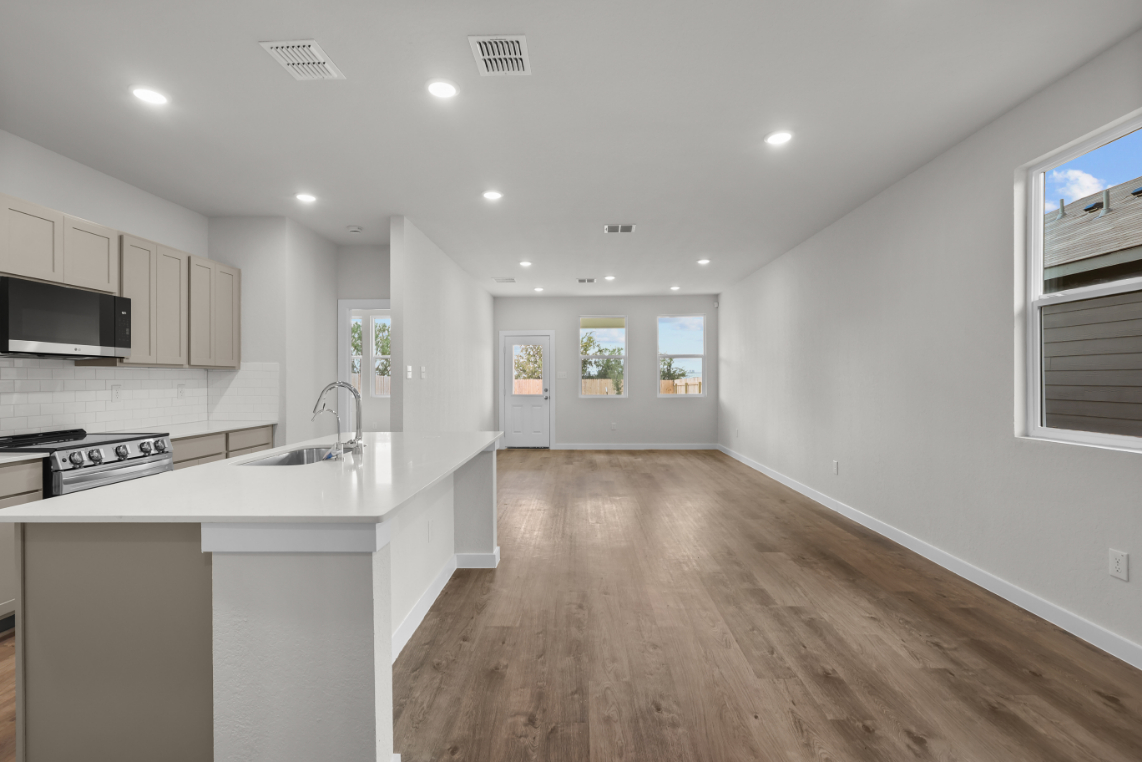 A kitchen with white cabinets.