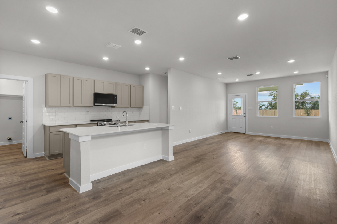 A large kitchen with white cabinets.