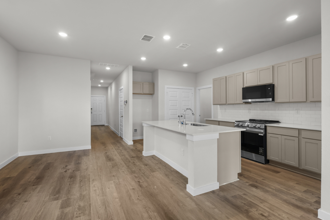 A kitchen with white cabinets.