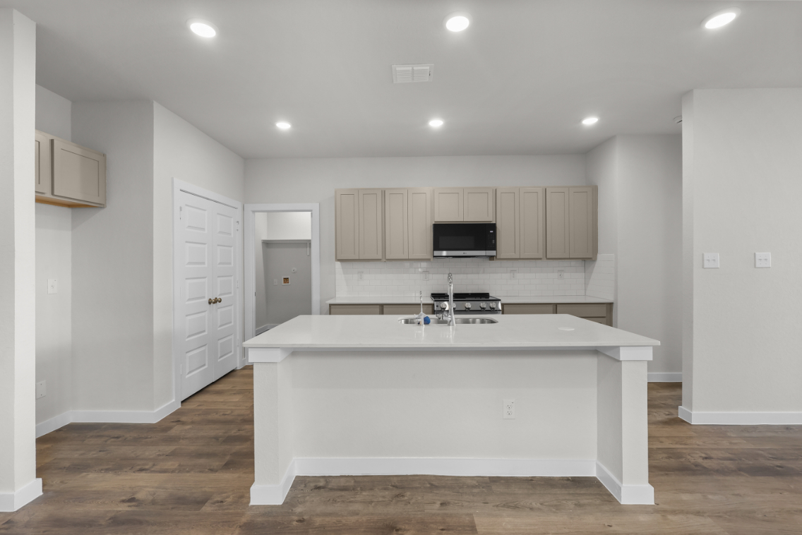 A kitchen with white cabinets.