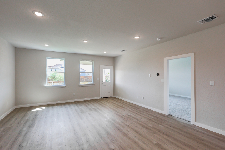 A room with a wood floor and a white door.