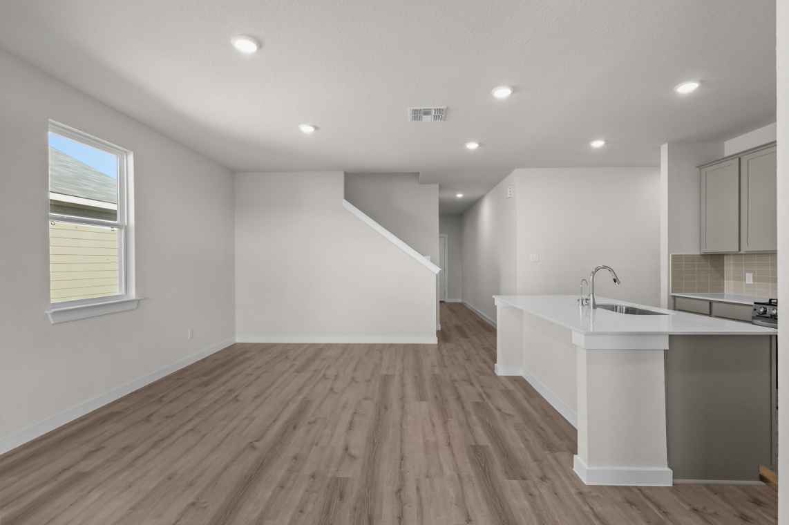 A kitchen with a wood floor.
