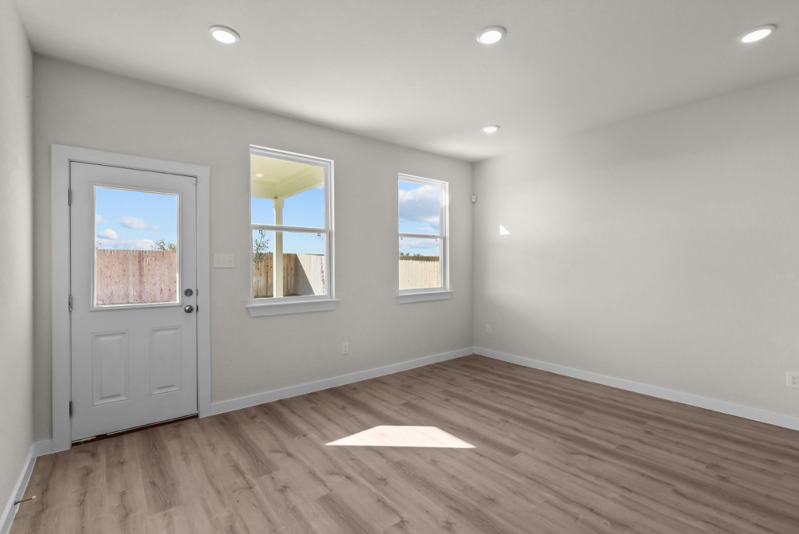 A room with a wood floor and white doors.