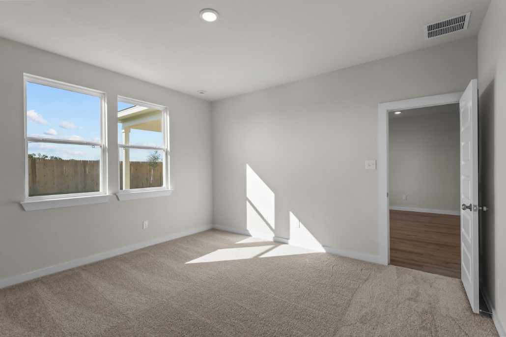 A room with a staircase and windows.