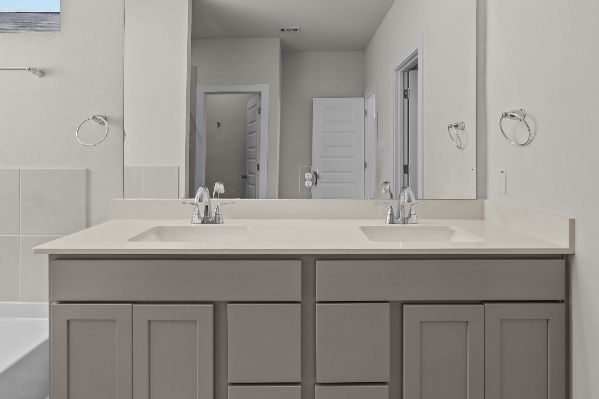 A bathroom with a large mirror.