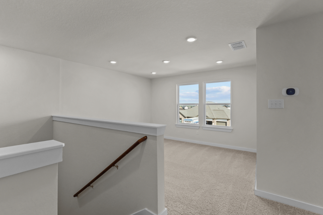 A room with a staircase and a window.
