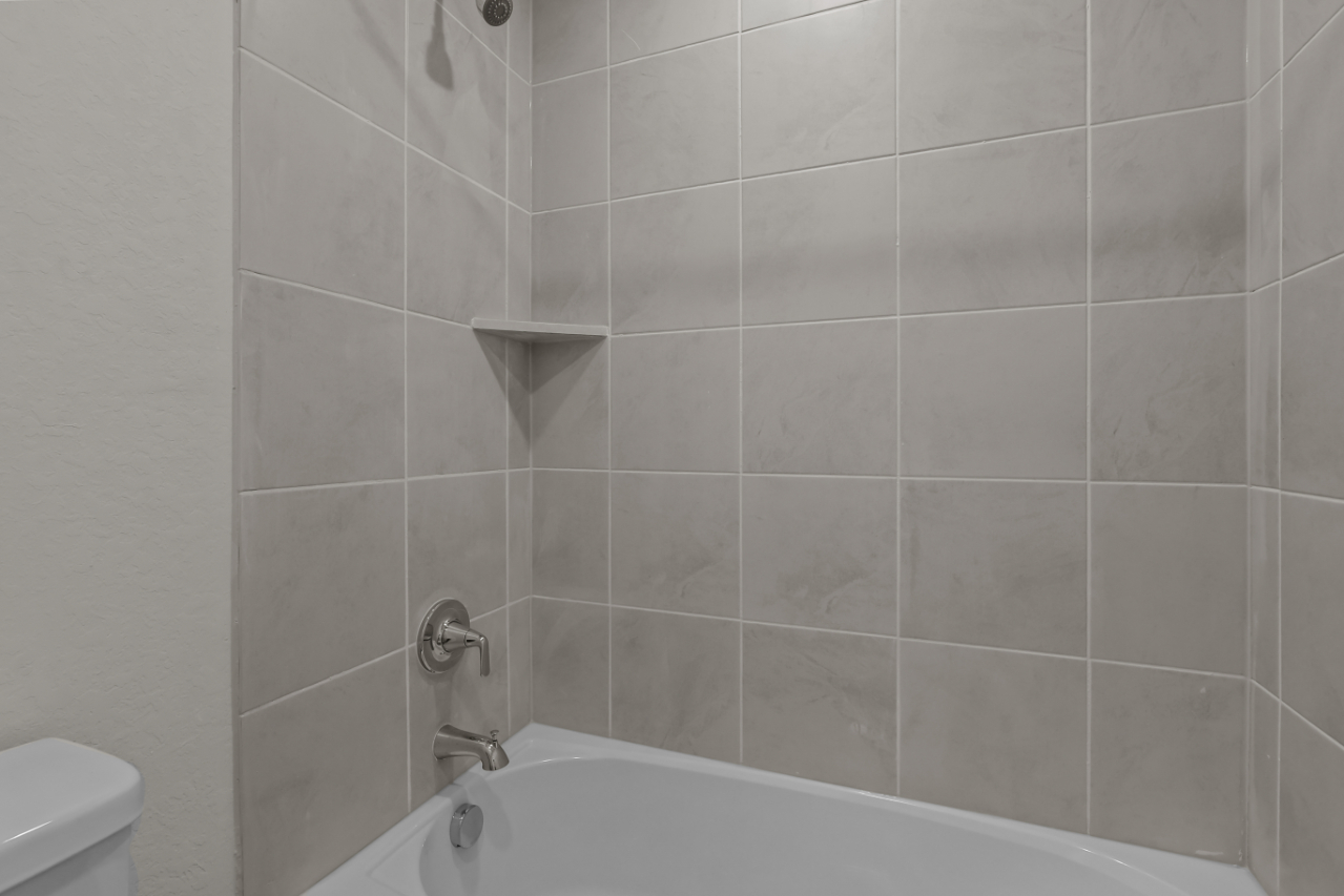 A bathtub in a bathroom.