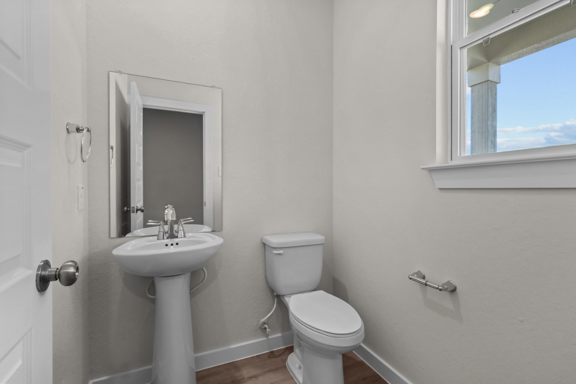 A bathroom with a toilet and sink.