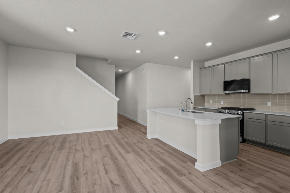 A kitchen with white cabinets.