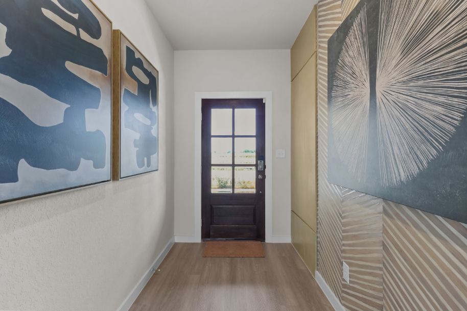 A hallway with a door and a window.