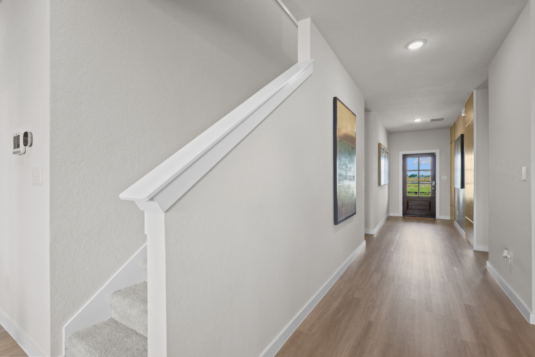 A hallway with white walls.