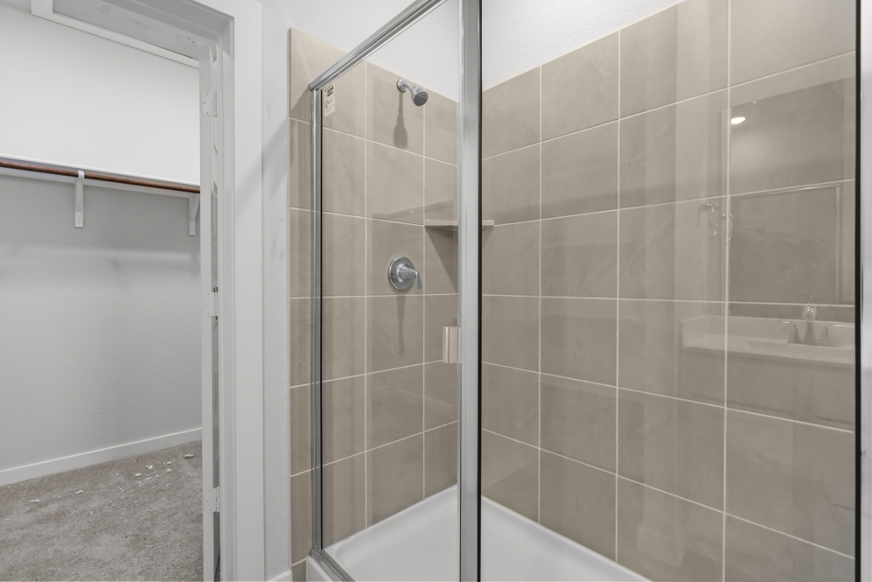 A shower with a glass door.