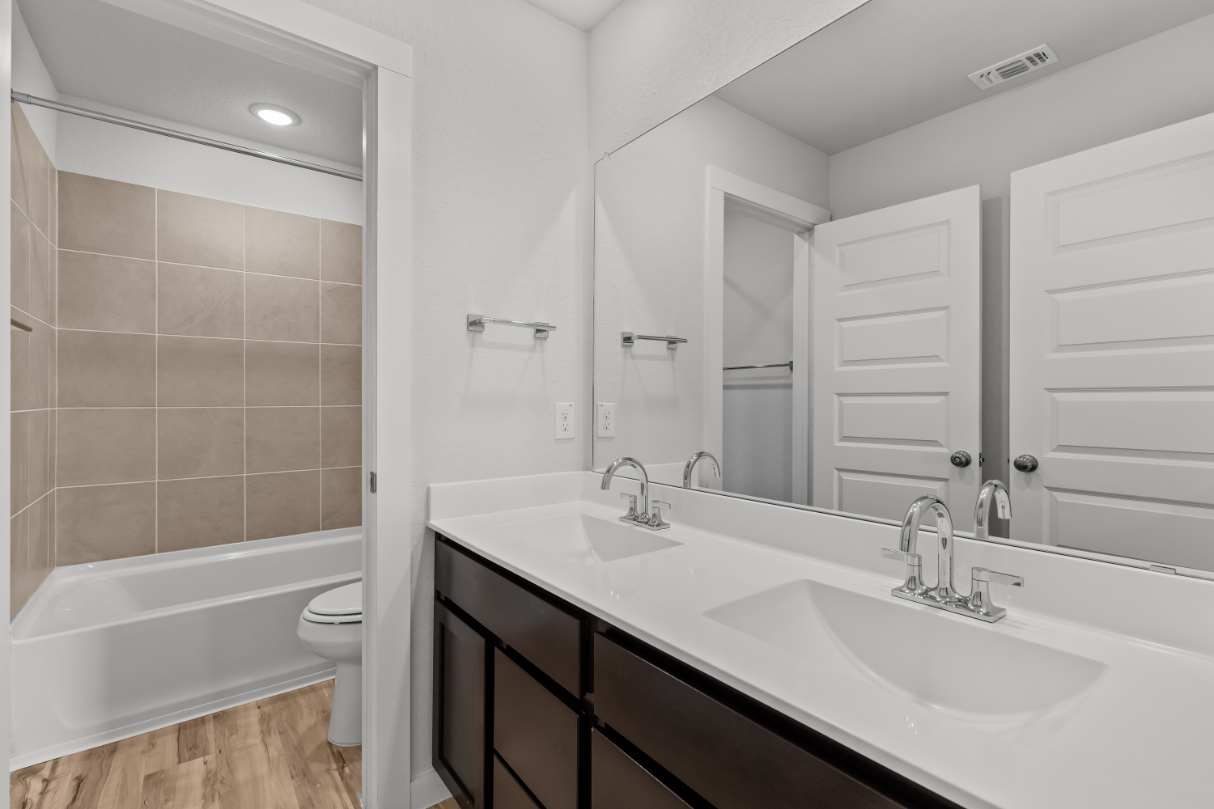 A bathroom with a tub sink and toilet.