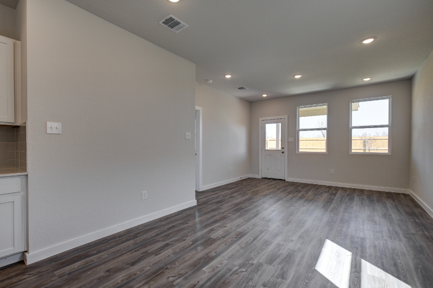 A room with a wood floor and white walls.